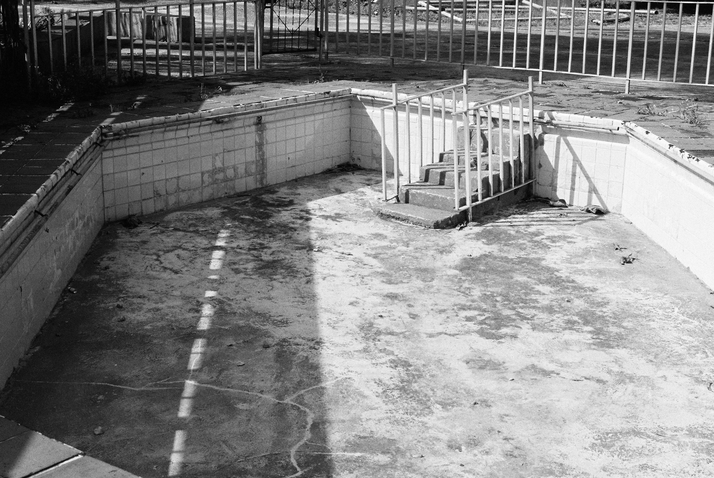 Drained swimming pool in hard light