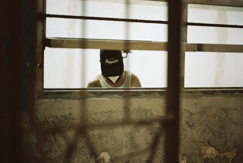 Cap through the barred workshop window, color