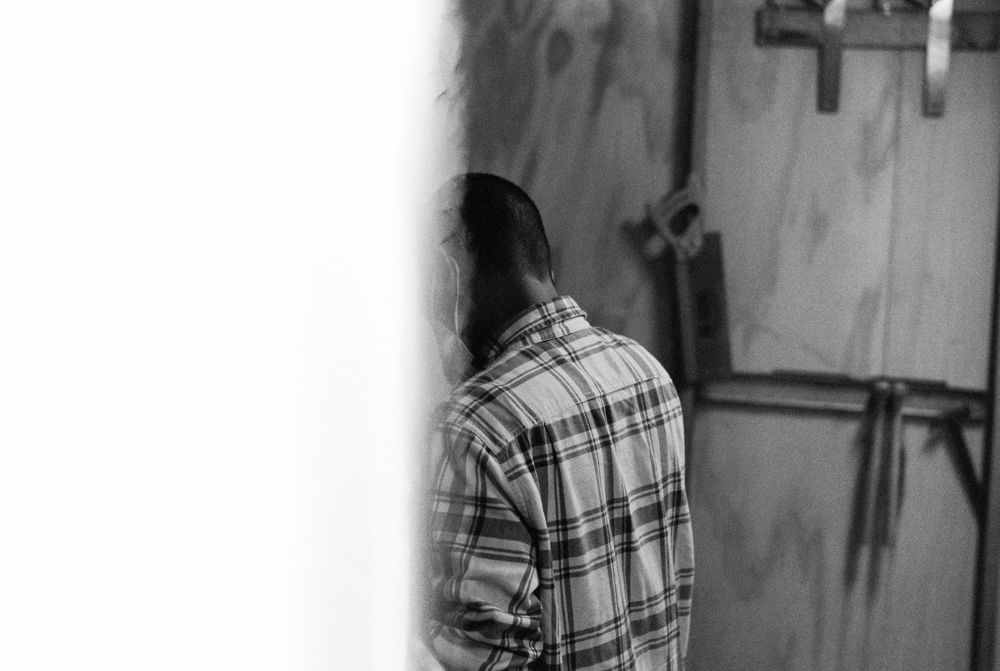 Plaid shirt against a white wall