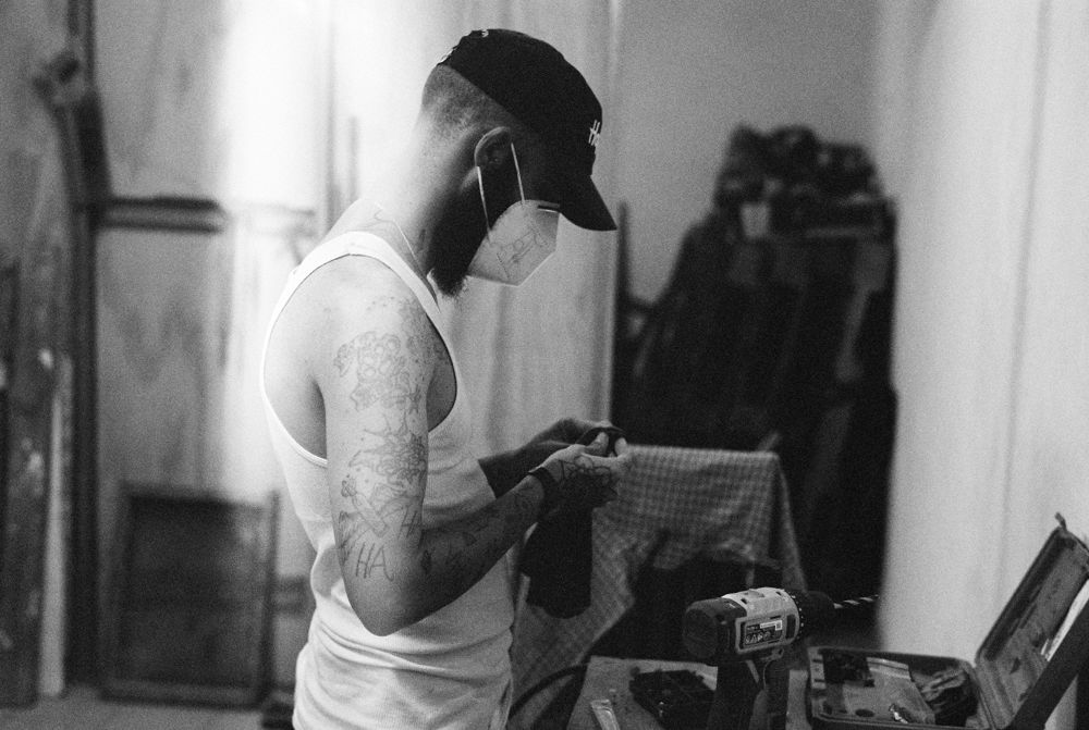 Builder in mask and cap working in the shop, black and white
