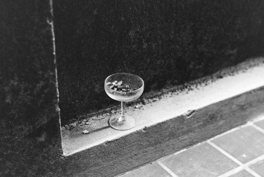 Coupe glass resting on a tiled ledge
