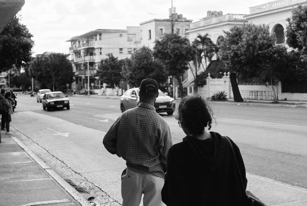 Two figures walking up the avenue