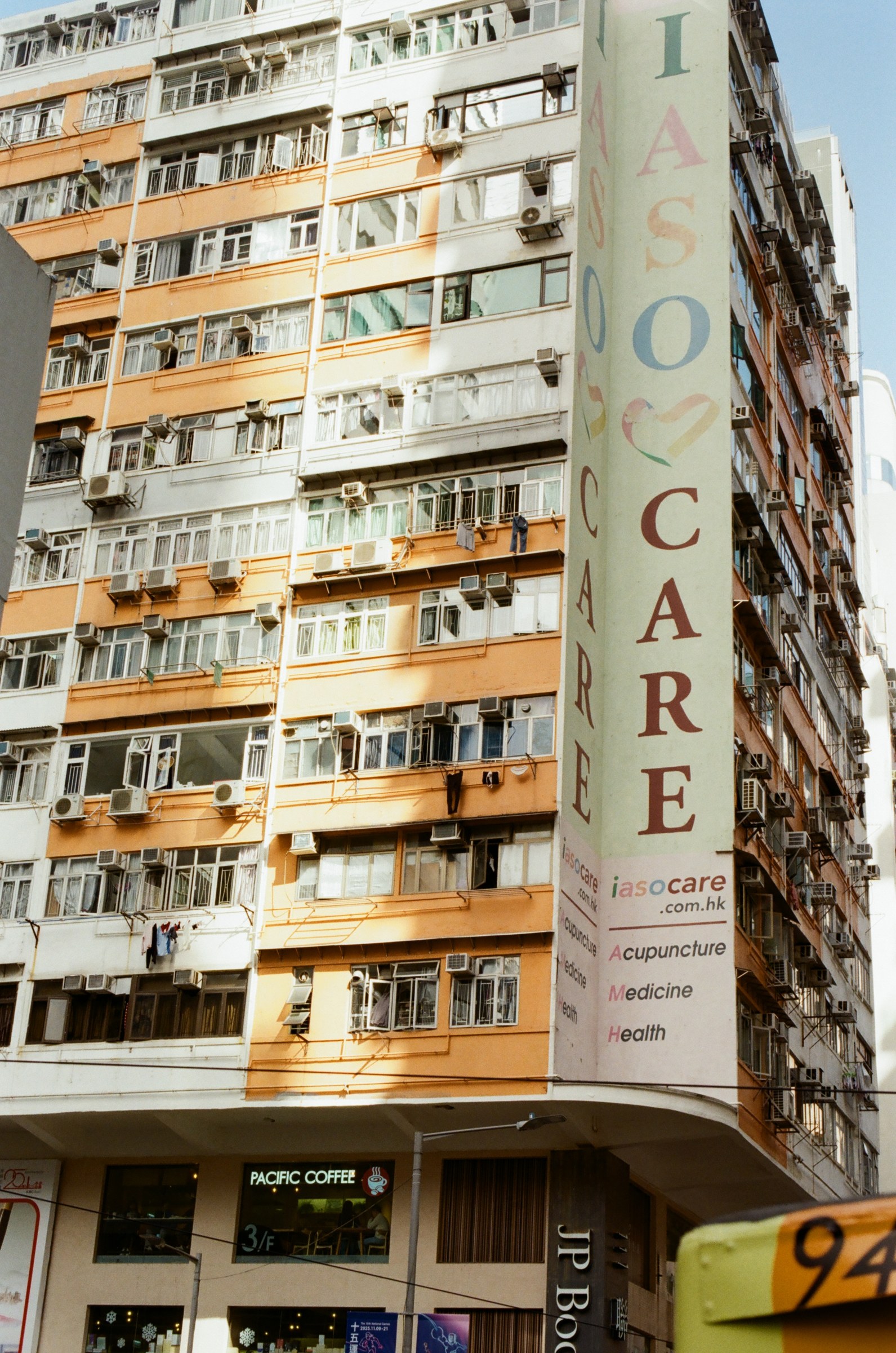 Orange apartment block with painted IASO CARE sign
