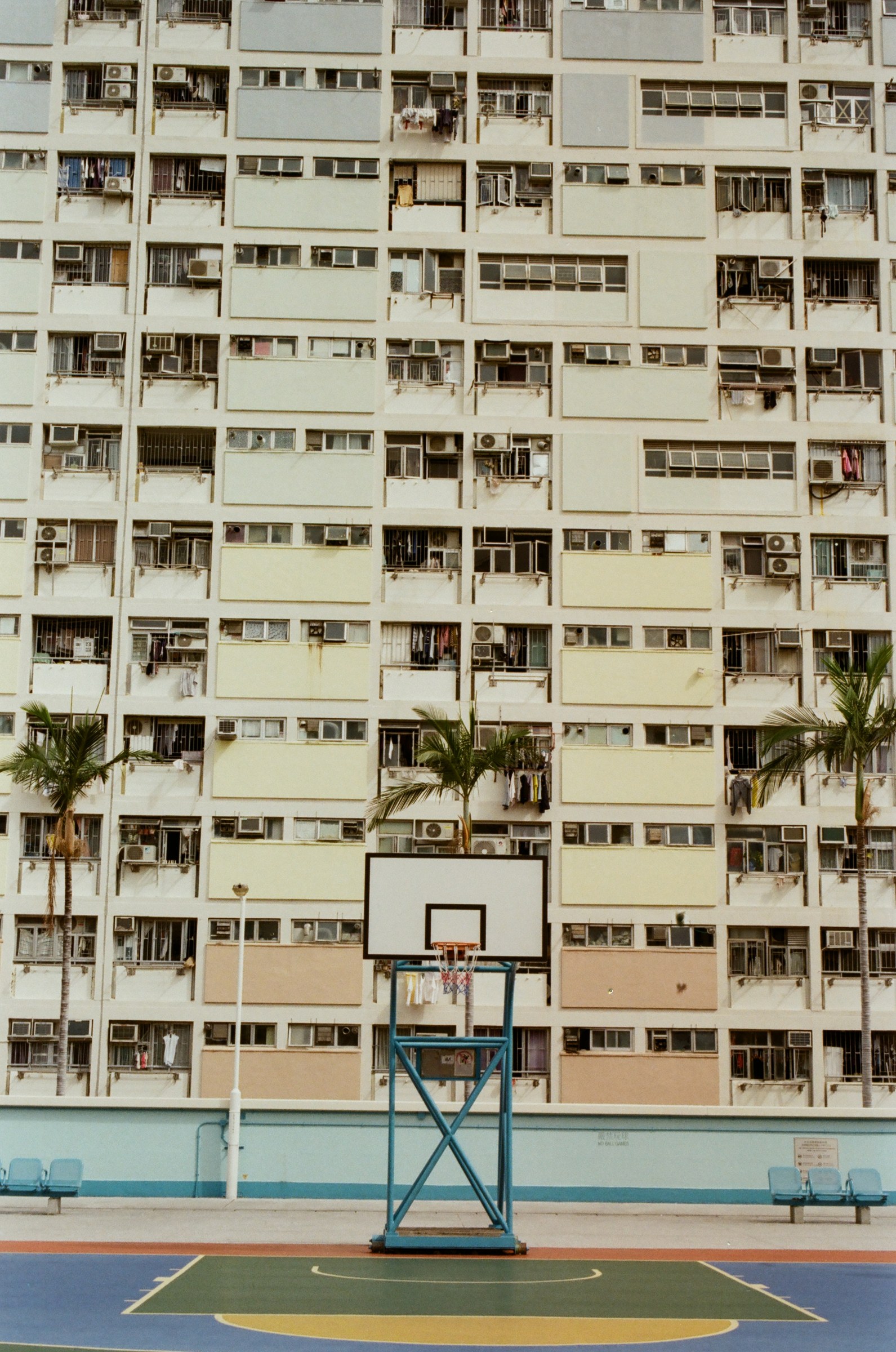 Basketball hoop against the pastel facade of Choi Hung Estate