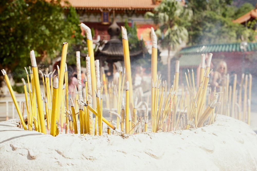 Incense sticks burning in sand at the monastery