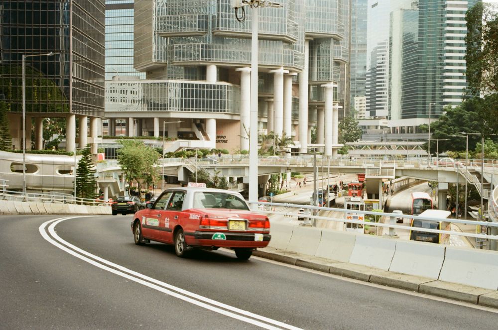 Red taxi sweeping through Central