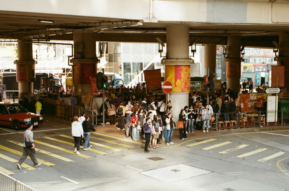 Crowd waiting under the flyover at a crossing